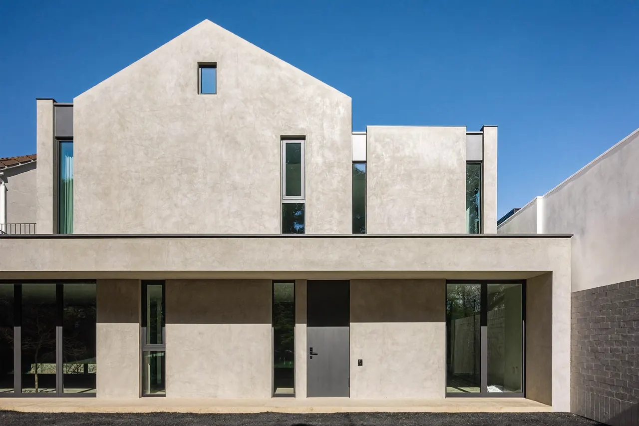 Slim grey aluminium windows on a modern rendered extension