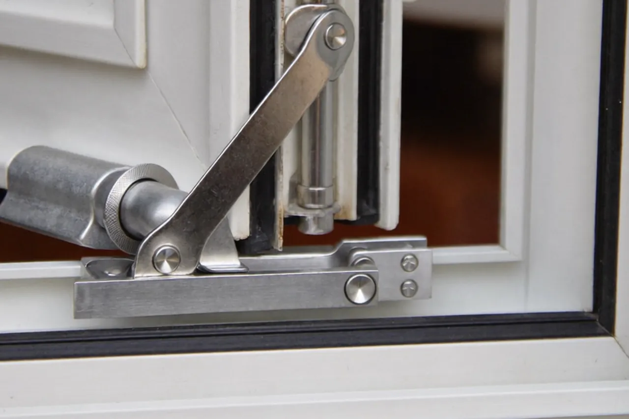 Hand applying lubricant to a window friction hinge
