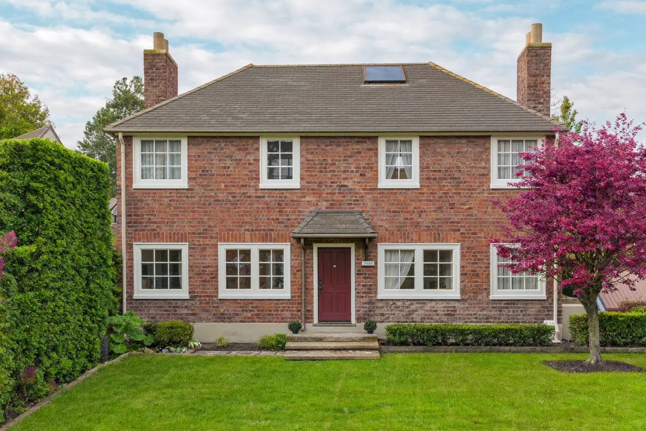White uPVC casement windows on a red-brick suburban semi