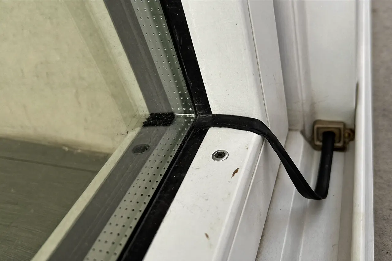 Detail of the rubber gasket seal around a window sash
